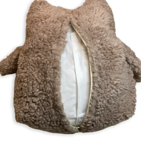 Rückseite Kuscheltier Eule in Farbe braun. Das Kuscheltier besteht aus Plüschstoff und ist 24 cm groß. Auf der Rückseite sieht man den geöffneten Zipp. Über diesen Zipp kann das Innenkissen entnommen werden. Die Flügeln stehen vom Körper ab und sind werden auch mit Plüschstoff in Farbe braun gefertigt.